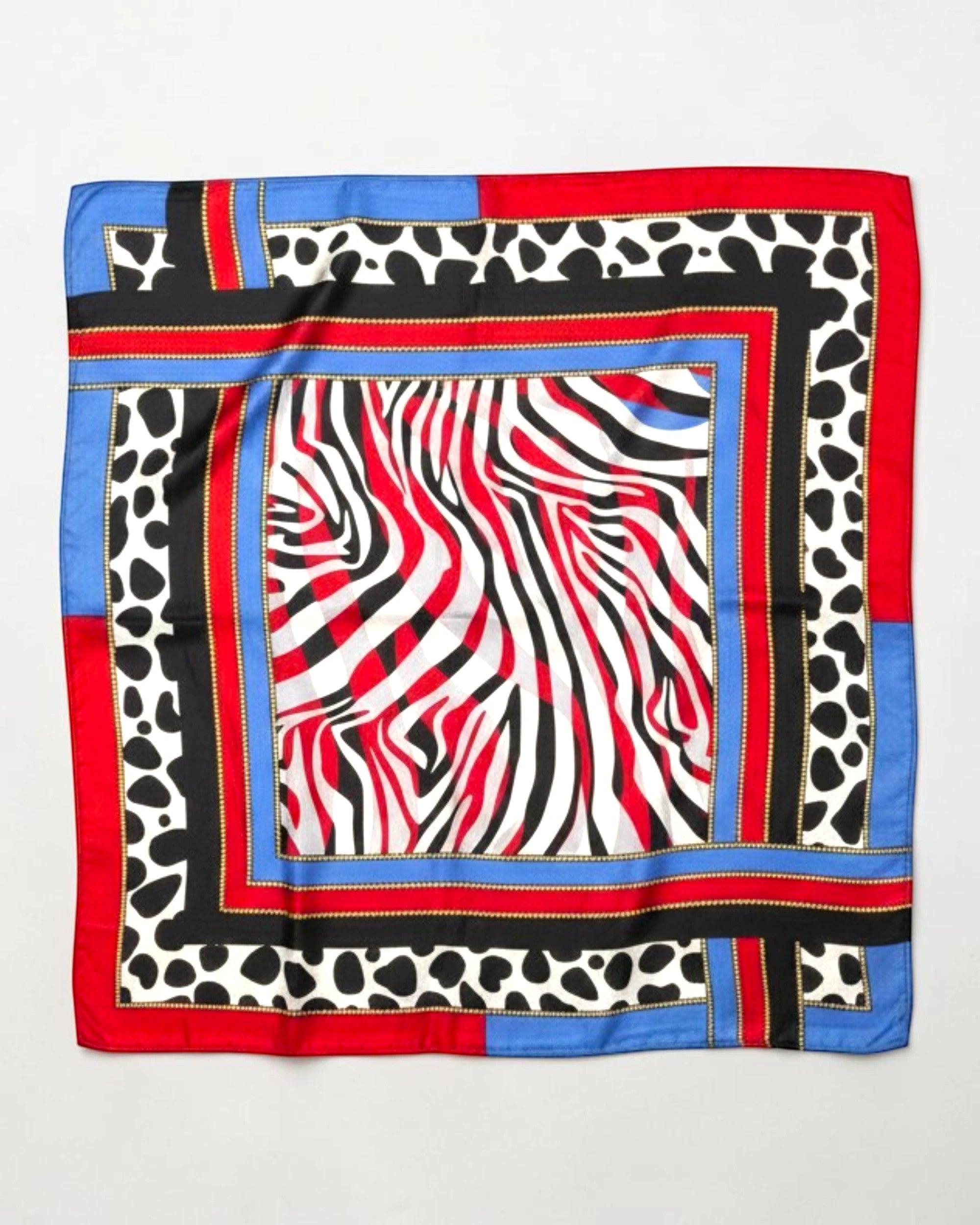 APA Studios silk scarf with zebra print in red, black, white, and blue, featuring a contrasting animal print border.
